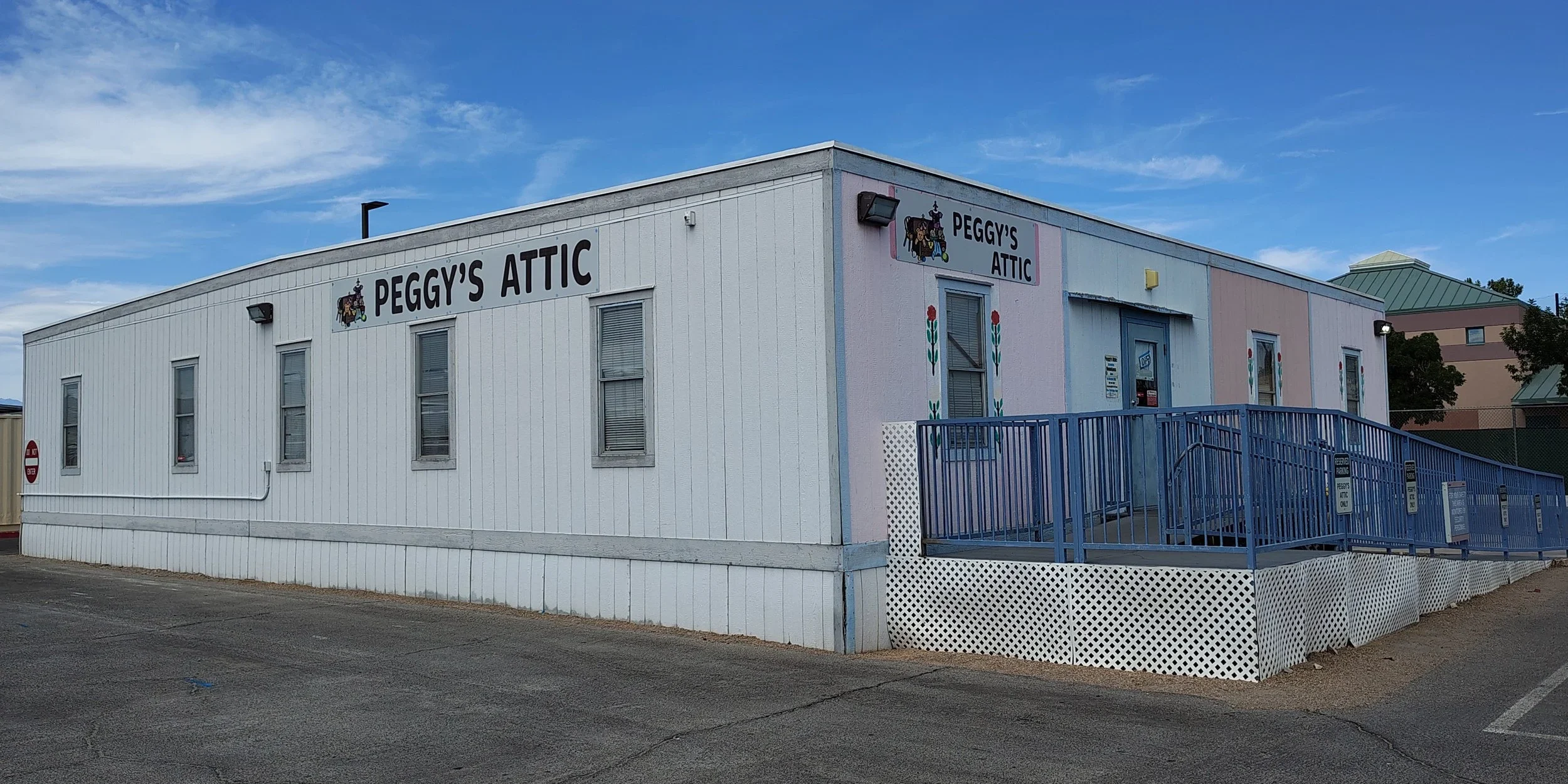 White building with "Peggy's Attic" sign.